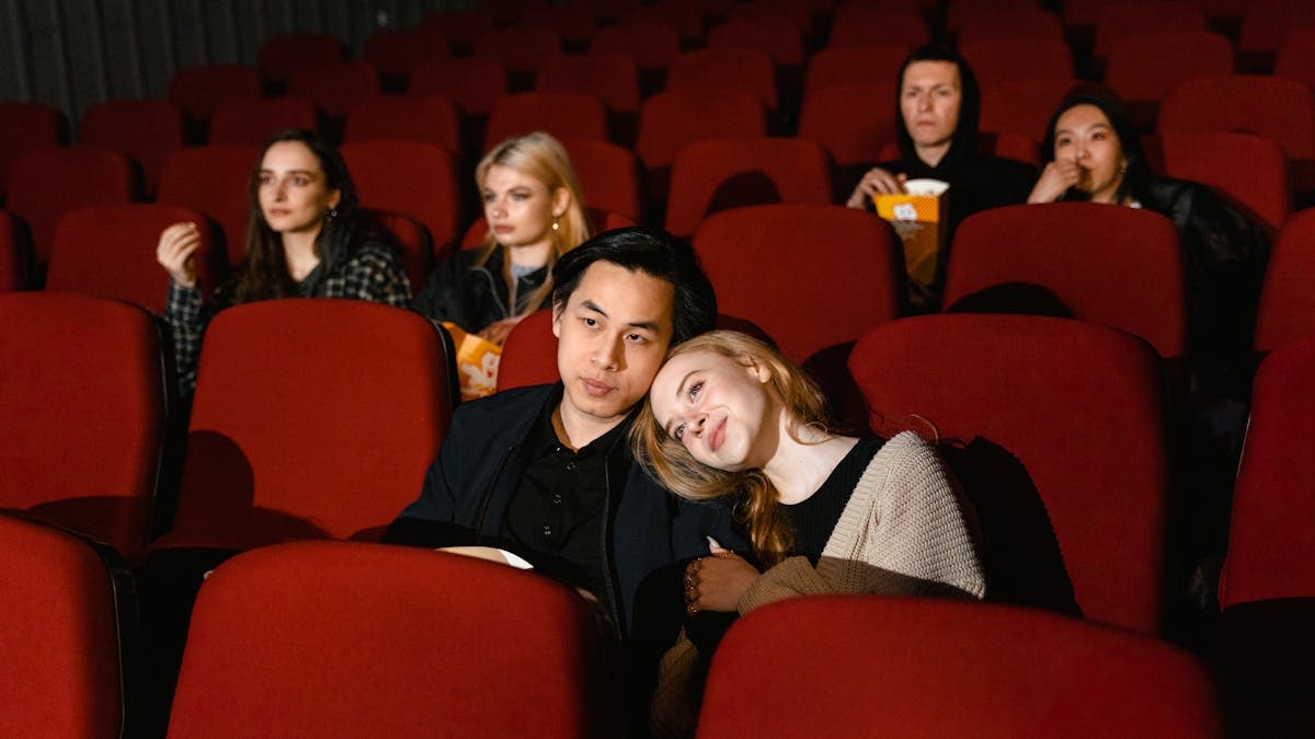 Multiple couples enjoying a movie in a cozy cinema setting, perfect for entertainment themes.